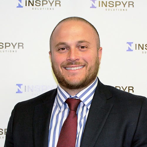 Brandon G. Smiling man in suit and tie.