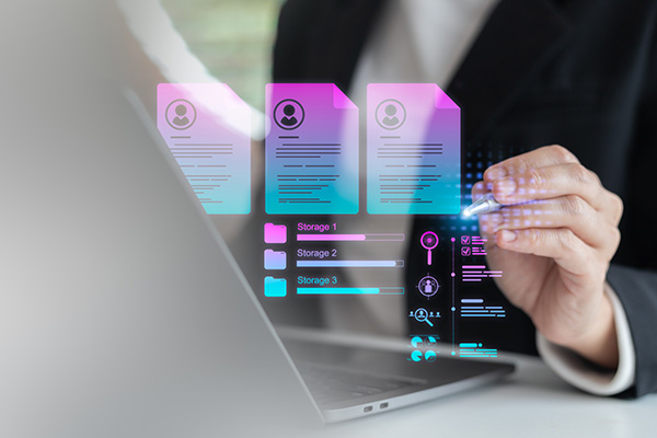 Businesswoman using a laptop with digital HR management, resume database, and cloud storage technology, concept of recruitment, job application, and workforce analytics.