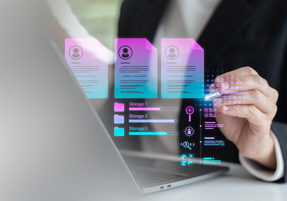 Businesswoman using a laptop with digital HR management, resume database, and cloud storage technology, concept of recruitment, job application, and workforce analytics.
