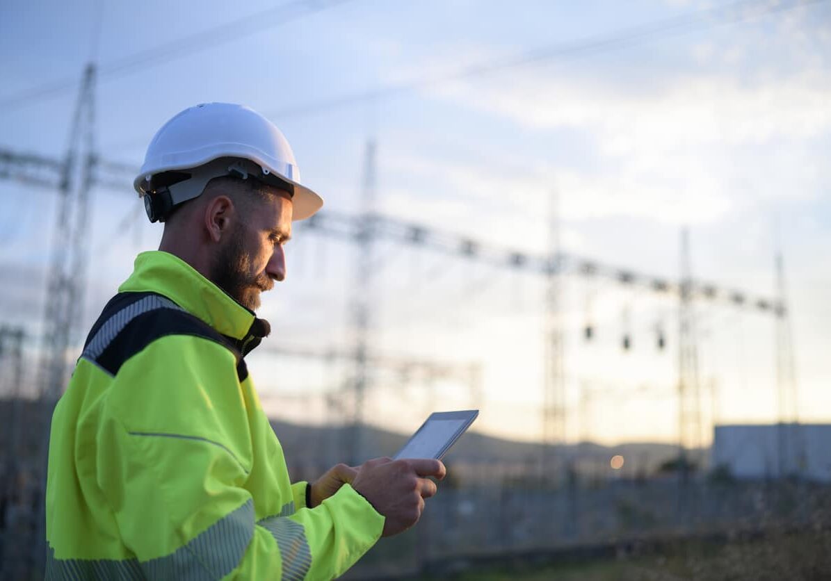 Young Electrical Engineer Using Digital Tablet For Work