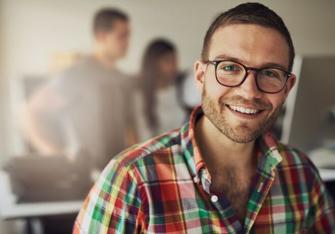 Horizontal portrait of a smiling office working man looking at camera.